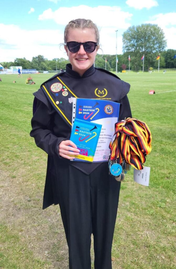 Adrienne Syron, Drum Major and assistant director, receiving awards on behalf of the band